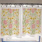 Floral and bird patterned curtains on a rod with a tiled floor background