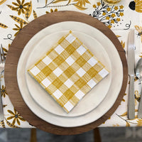 bundle of tabletop products - white table runner with bee and floral elements, gold gingham cloth napkins
