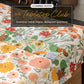 The Tabletop Club seasonal table linens featuring colorful floral designs on a beautifully set table.