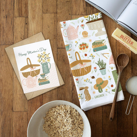 Kitchen-themed Mother's Day card, tea towel, and butter on a wooden surface