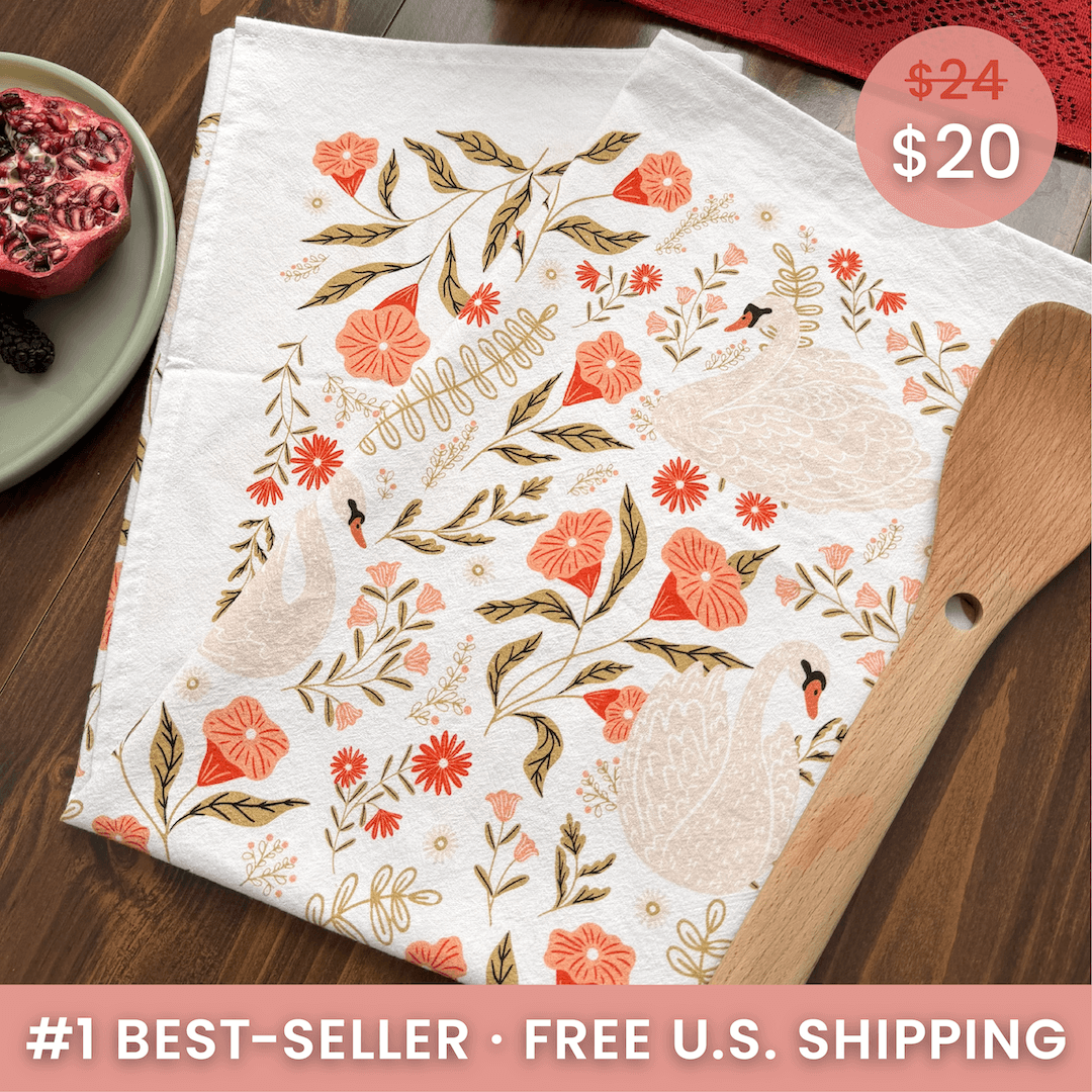 Floral-patterned towel on a wooden surface with a price tag and promotional text.