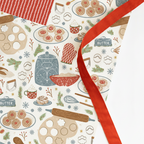 Patterned paper with baking-themed illustrations and a red ribbon.