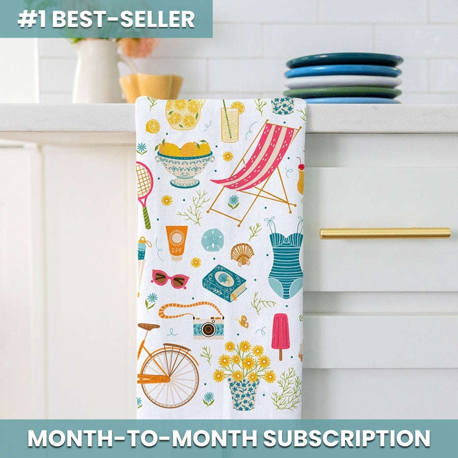 Colorful towel with summer-themed design hanging on a kitchen rack.