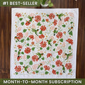 Decorative tablecloth with floral and bird pattern on a wooden surface, labeled as a best-seller with a month-to-month subscription offer.