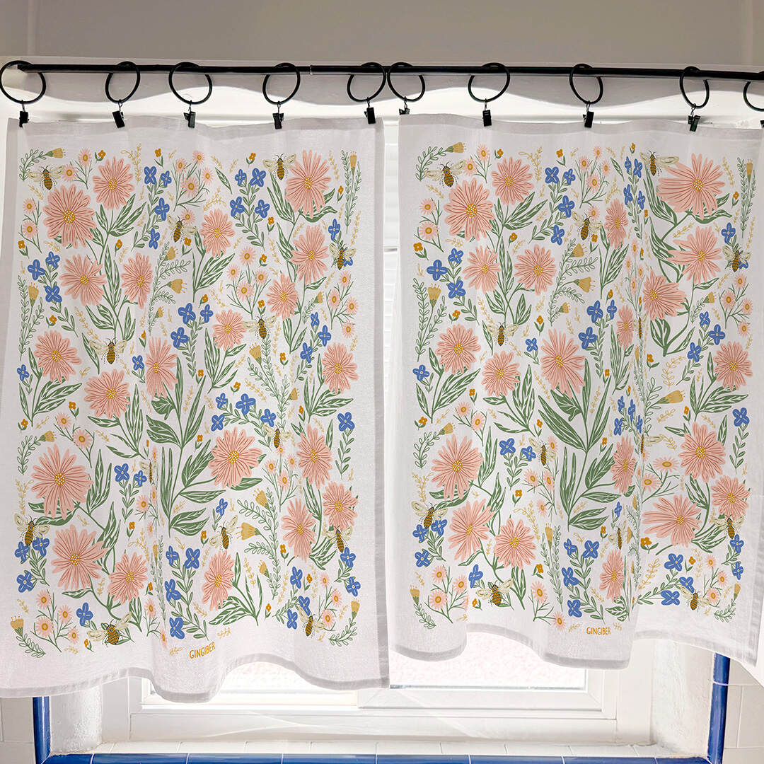 Floral patterned cafe curtain with pink flowers and green leaves on a white background.