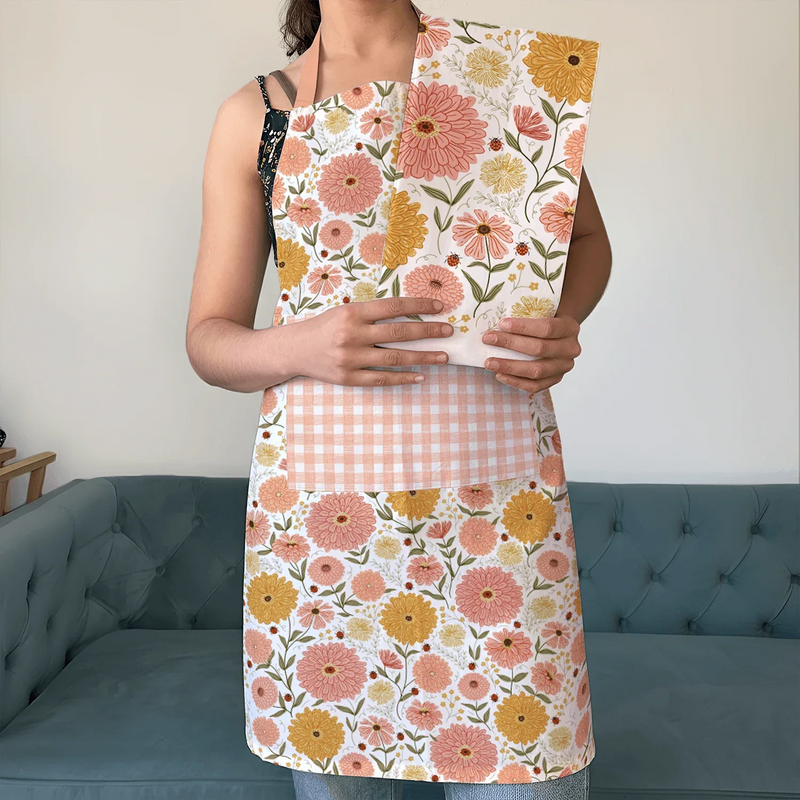 Zinnia Apron and Tea Towel Bundle featuring floral designs and a large pocket for kitchen use.