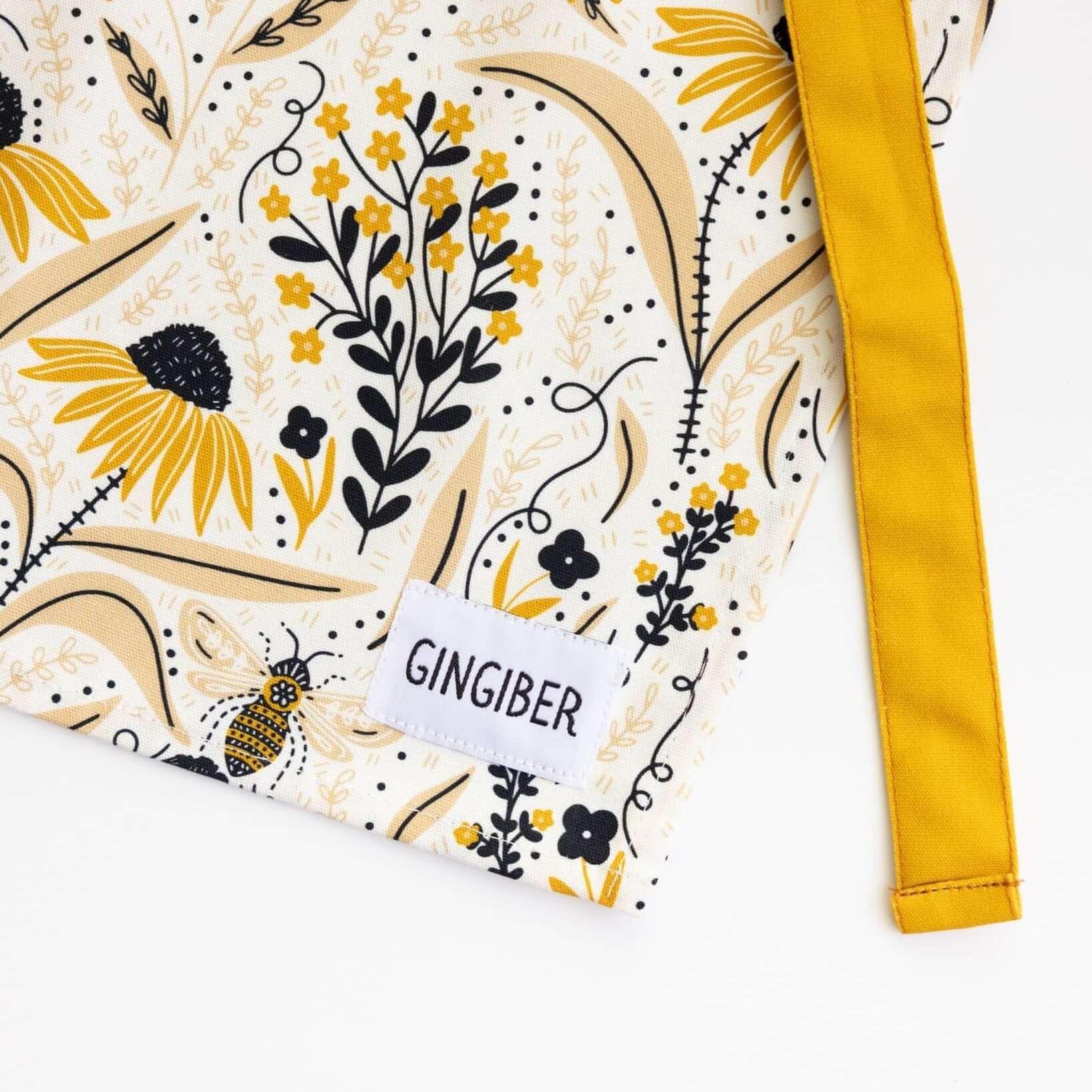 Bee Garden Apron—bake in style with gingiber apron featuring bee & floral print, adjustable neck strap, large pocket, 100% cotton canvas