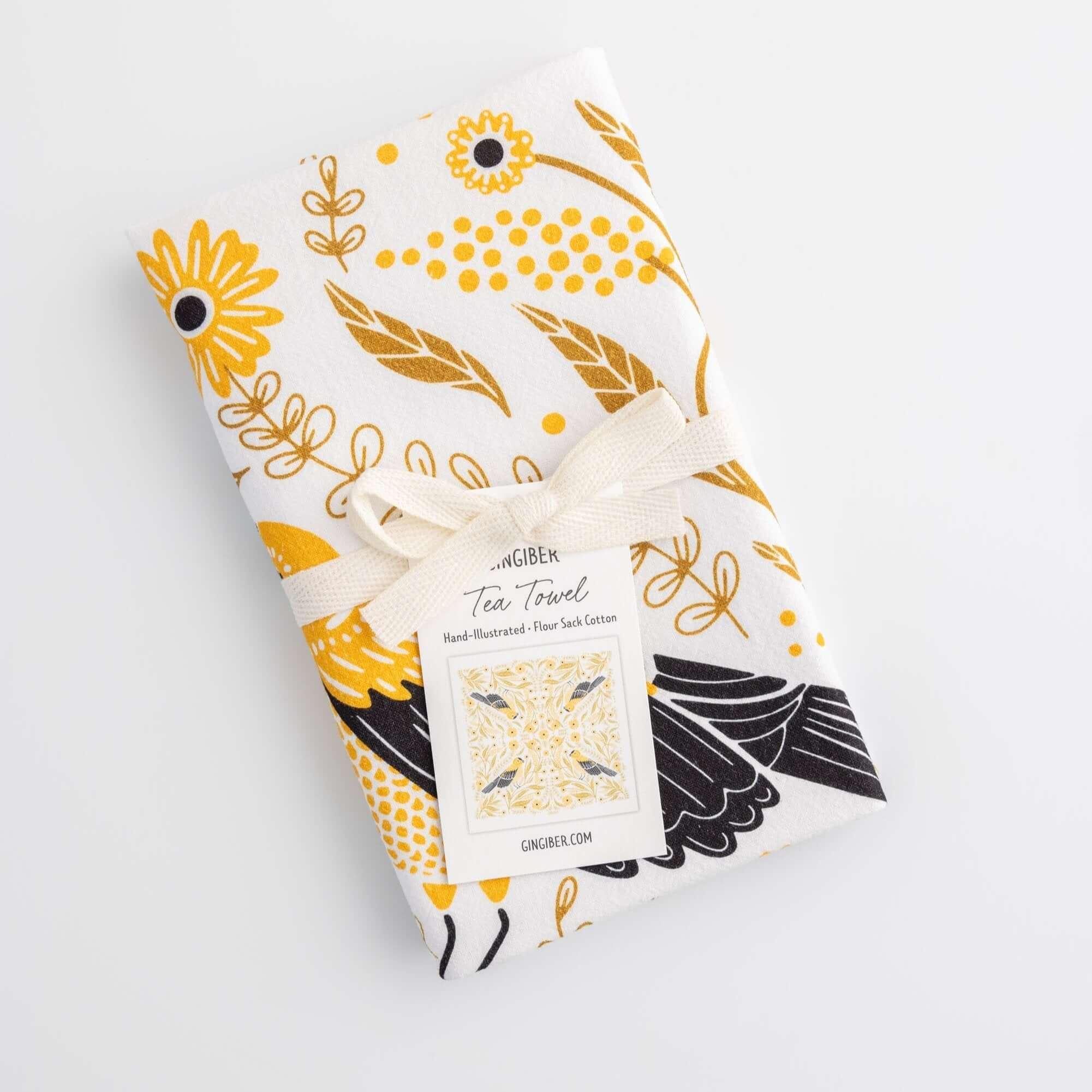 tea towel with illustrated birds and floral elements