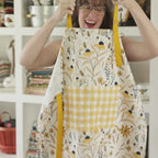 Bee Garden Apron—bake in style with gingiber apron featuring bee & floral print, adjustable neck strap, large pocket, 100% cotton canvas