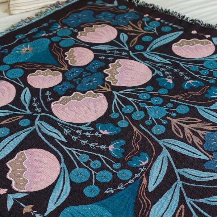 blanket with pink and dark blue floral designs